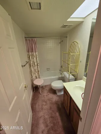 a living room with furniture a rug and a window