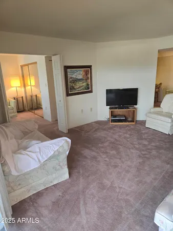 a bedroom with a bed and a television