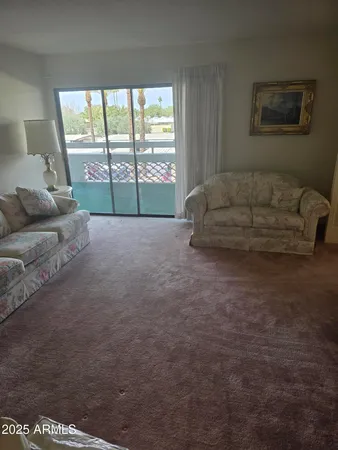 a living room with furniture and a large window
