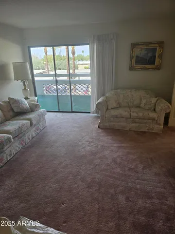 a living room with furniture and a large window