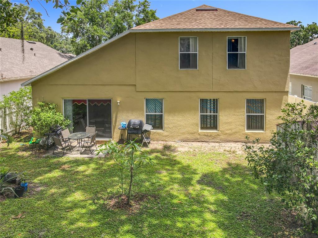 7939 Riffle Lane Orlando, FL 32818 - Photo 45 of 52 a view of a house with backyard and sitting area