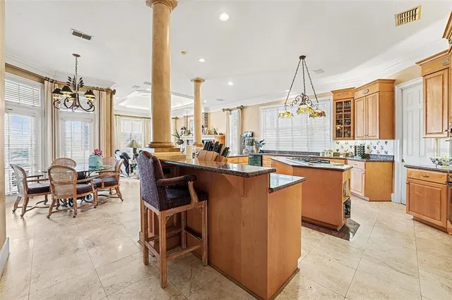 a kitchen with stainless steel appliances granite countertop a stove a sink a oven and a refrigerator