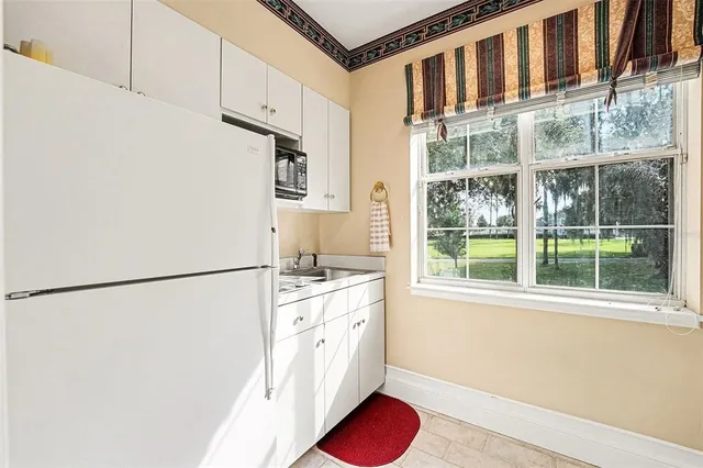 a bedroom with a bed mirror and a window