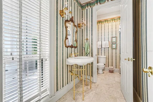 a bathroom with a glass shower door and a mirror