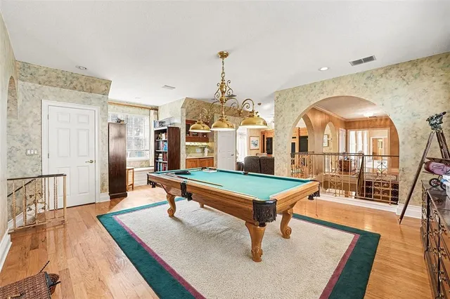 an aerial view of residential houses with outdoor space and trees