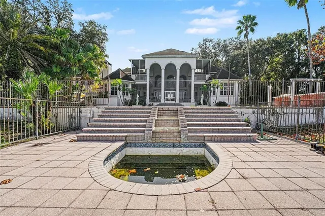 a view of a house with backyard and sitting area