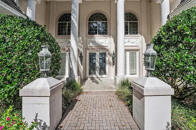 a living room with furniture a fireplace and a chandelier