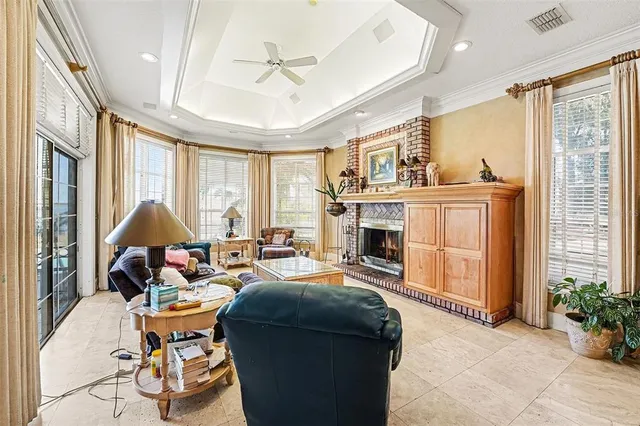 a living room with furniture and large windows