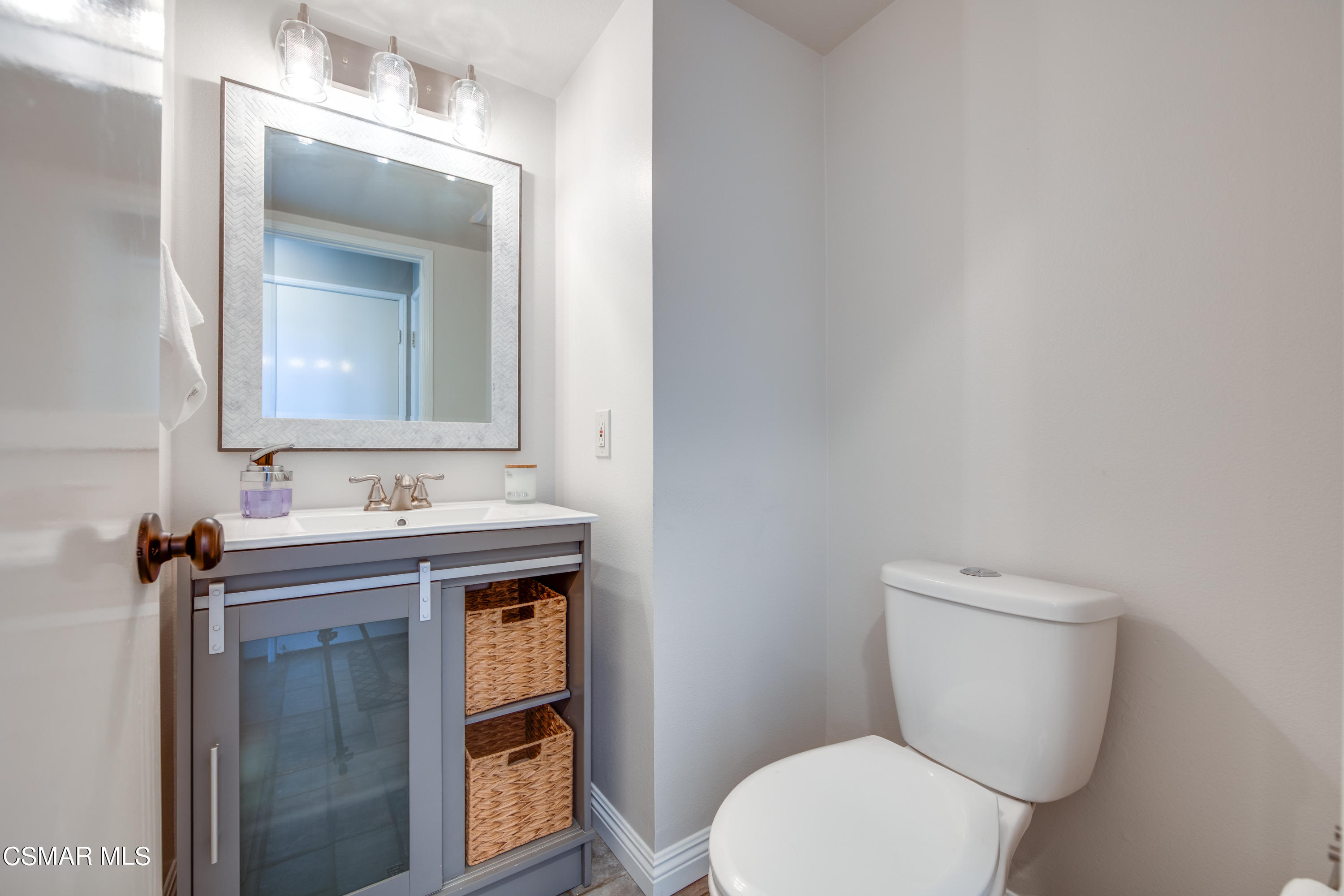 1763 Empty Saddle Road Simi Valley, CA 93063 - Photo 8 of 36 a bathroom with a toilet a sink and mirror