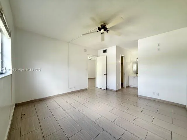 an empty room with white walls and entryway
