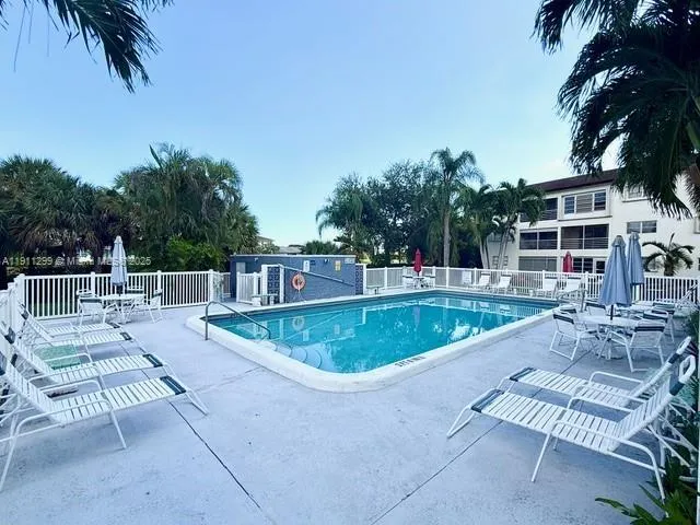 a view of a swimming pool with a patio