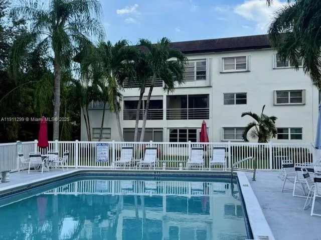 a swimming pool view with a outdoor seating