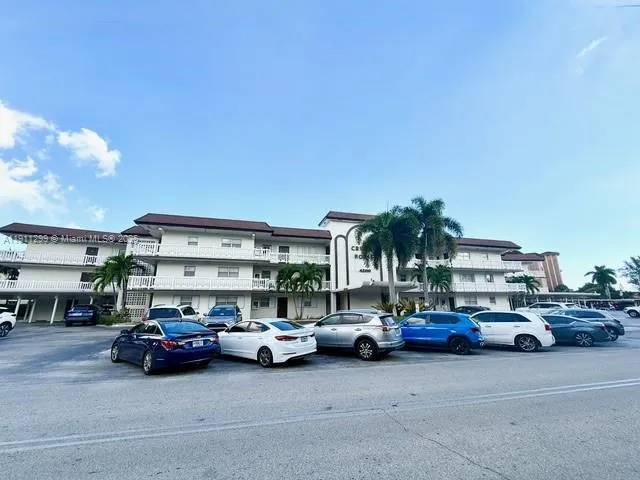 a view of cars parked in front of a building