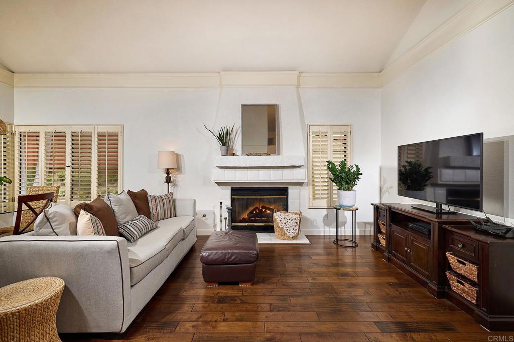 1134 Calle Christopher Encinitas, CA 92024 - Photo 12 of 37 a living room with furniture a flat screen tv and a fireplace