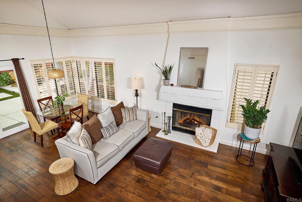 1134 Calle Christopher Encinitas, CA 92024 - Photo 14 of 37 a living room with furniture a fireplace and a potted plant