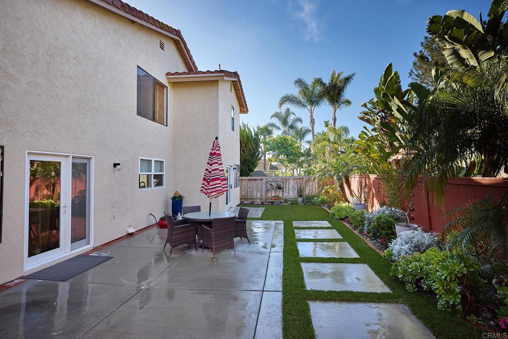 1134 Calle Christopher Encinitas, CA 92024 - Photo 19 of 37 a backyard of a house with table and chairs potted plants