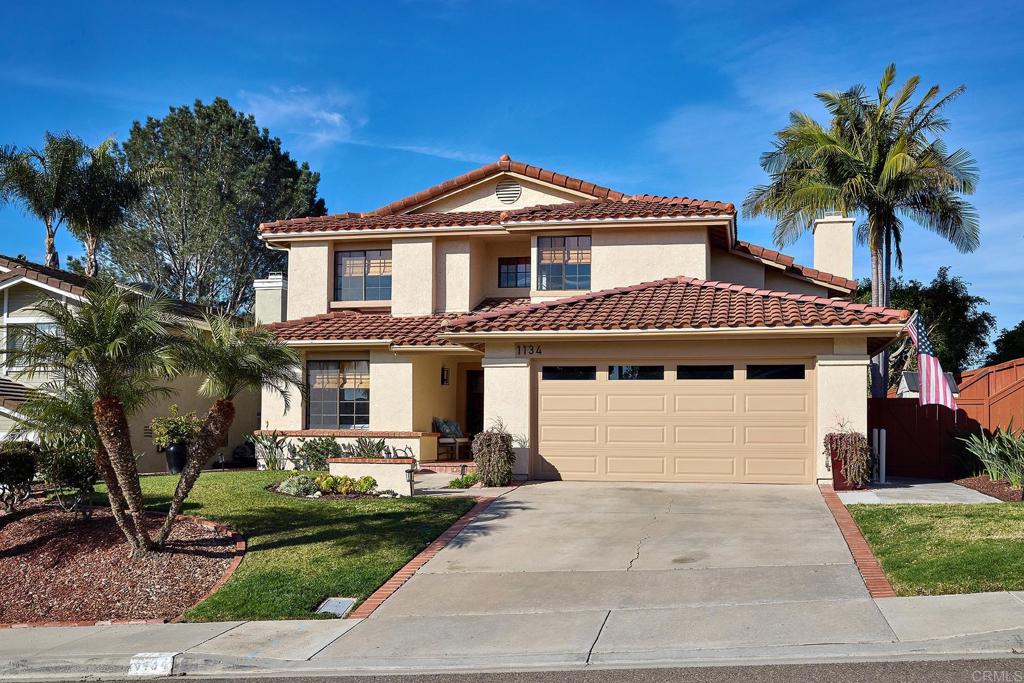 1134 Calle Christopher Encinitas, CA 92024 - Photo 2 of 37 a front view of a house with a yard and garage