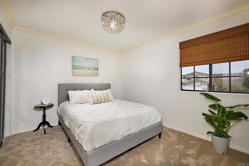 1134 Calle Christopher Encinitas, CA 92024 - Photo 26 of 37 a bedroom with a bed and a window