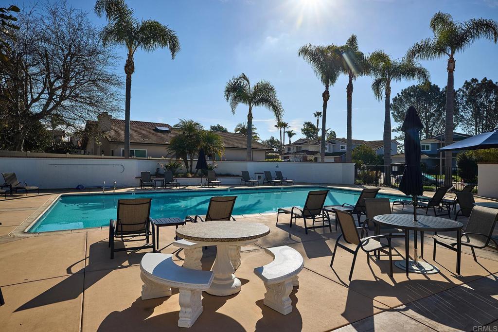 1134 Calle Christopher Encinitas, CA 92024 - Photo 33 of 37 a view of a patio with table and chairs potted plants and palm tree