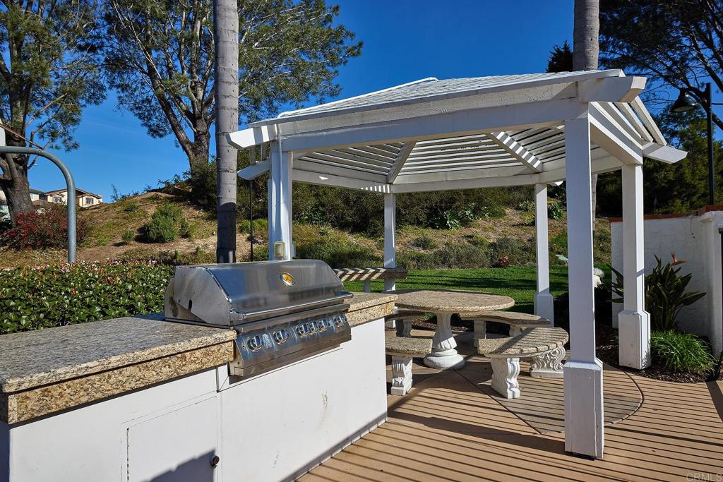 1134 Calle Christopher Encinitas, CA 92024 - Photo 35 of 37 a view of a patio with table and chairs potted plants and large tree