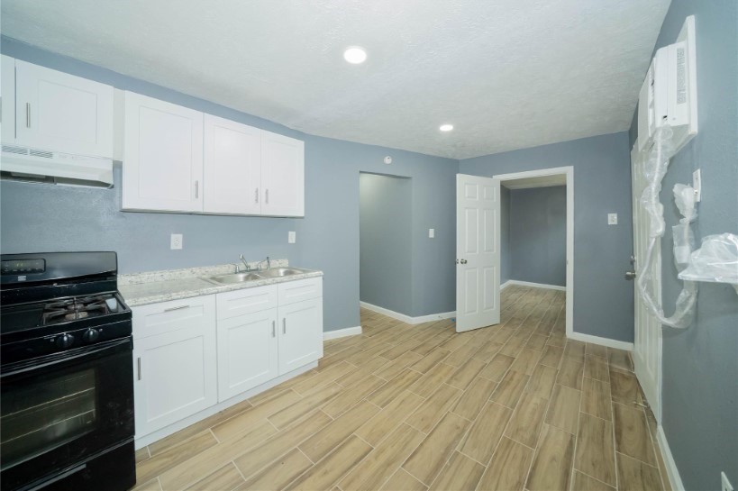 a kitchen with a sink stove and cabinets