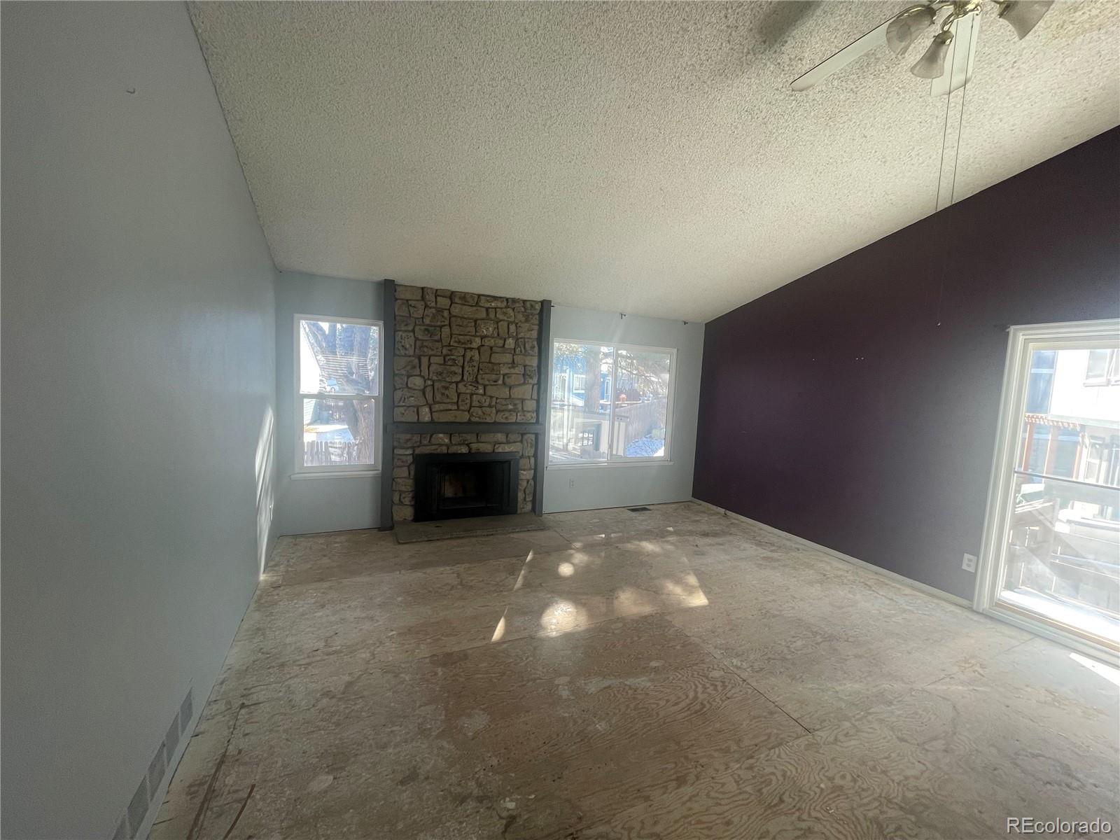 3817 South Ceylon Way Aurora, CO 80013 - Photo 3 of 18 a view of empty room with a fireplace