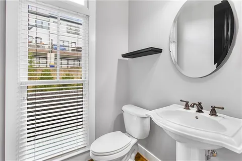 a white toilet sitting next to a bathroom sink