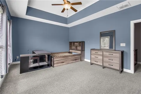 a room with a bed and a chandelier