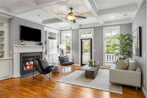a living room with furniture fireplace and flat screen tv