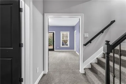 a view of entryway and hall with a front door