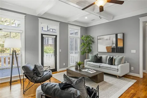 a living room with furniture and wooden floor