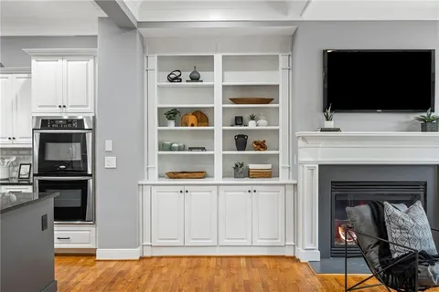 a living room with flat screen tv and a fireplace