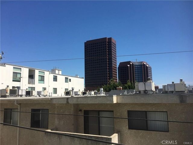 a kitchen with a sink a stove and wooden floor