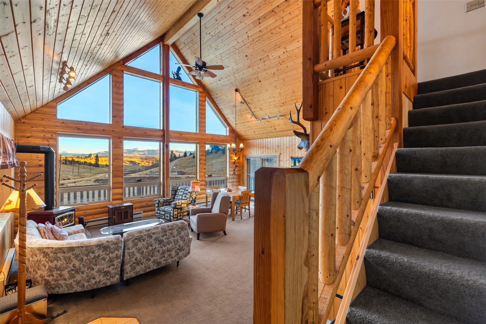 1081 Travois Road Como, CO 80456 - Photo 22 of 44 a living room with furniture and a floor to ceiling window
