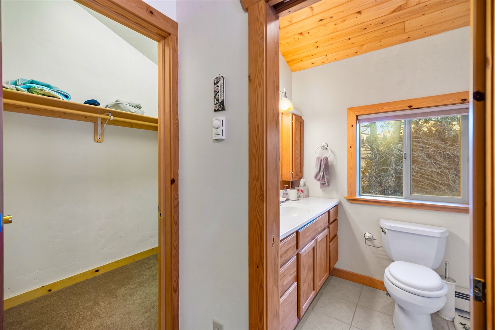 1081 Travois Road Como, CO 80456 - Photo 28 of 44 a bathroom with a sink a toilet and a window