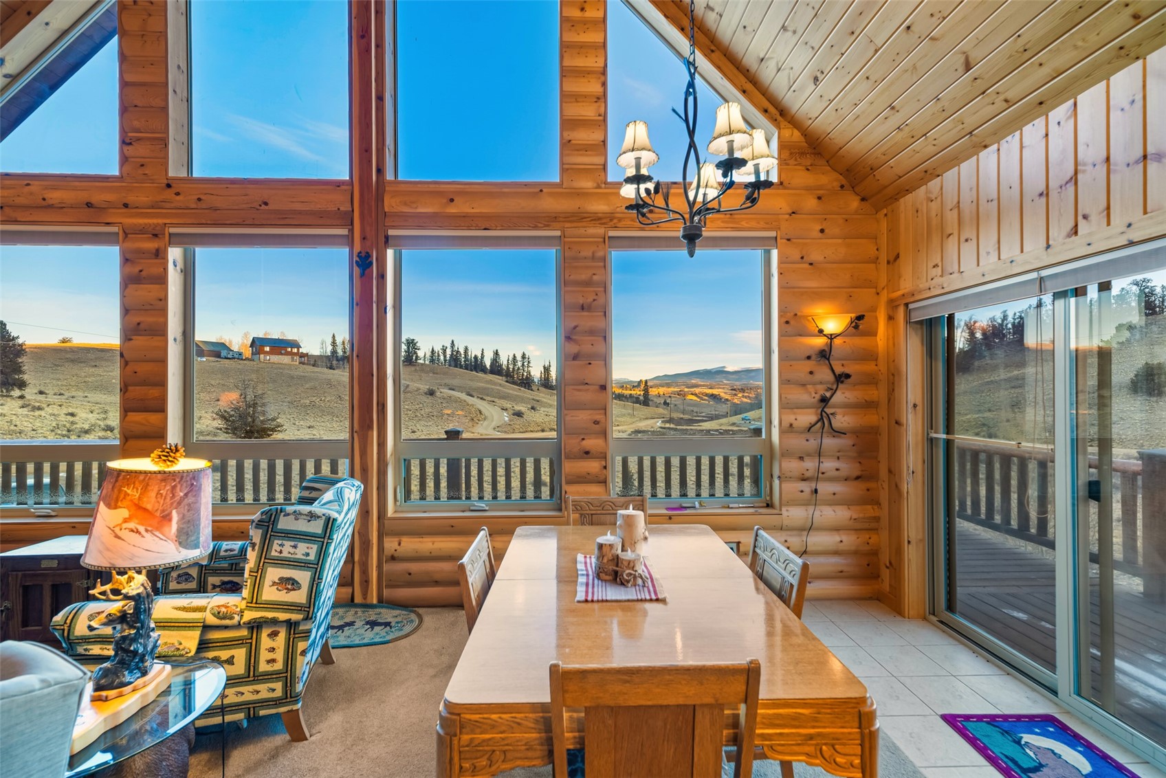 1081 Travois Road Como, CO 80456 - Photo 10 of 44 a balcony with hardwood filled with glass top table and chairs