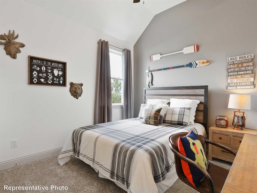 2204 Ridgecrest Lane Anna, TX 75409 - Photo 13 of 17 Bedroom featuring a vaulted ceiling and a window with gray drapes