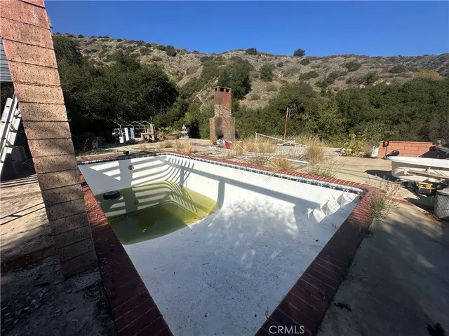 a park view with a barbeque