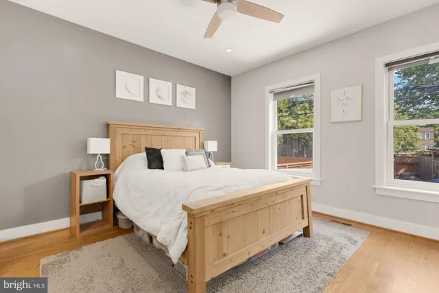 a bed sitting in a spacious bedroom next to a window