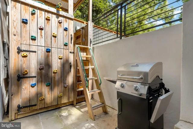 a balcony with couple of chairs and a window