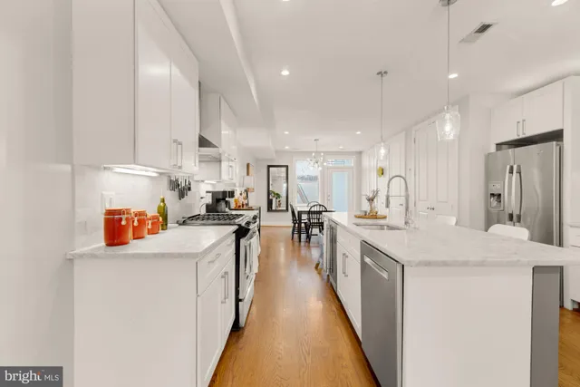 a kitchen with stainless steel appliances granite countertop a sink and cabinets