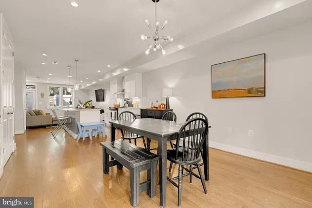 a dining room with furniture and wooden floor