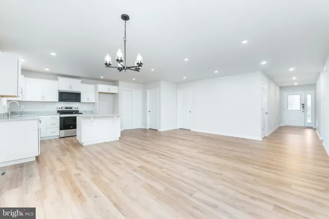 a kitchen with kitchen island white cabinets stainless steel appliances and sink