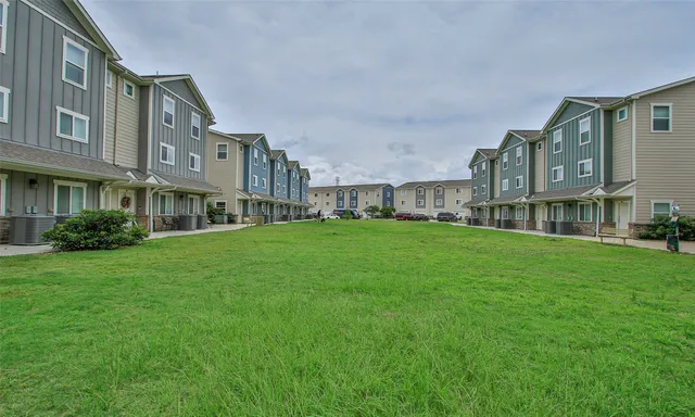 a brick building with a yard in front of it