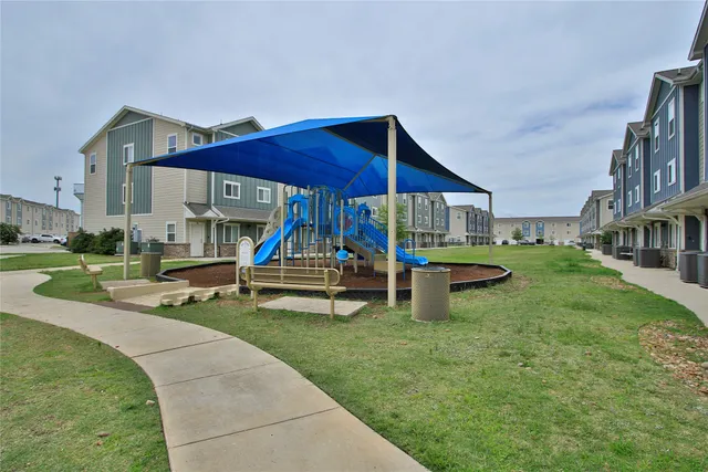 a view of a house with backyard porch and sitting area