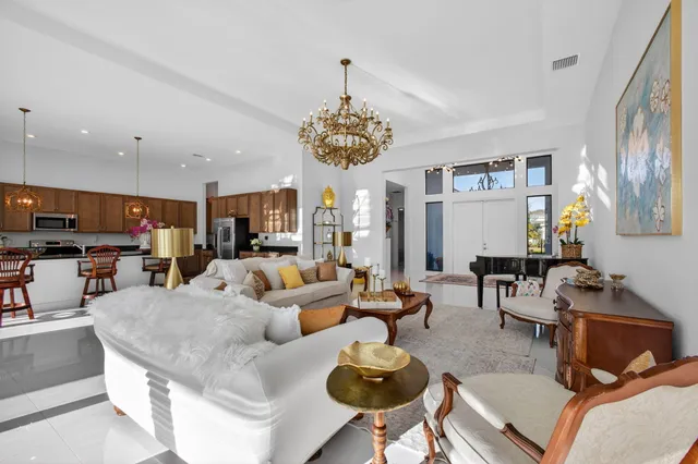 a kitchen with granite countertop a refrigerator and a stove top oven