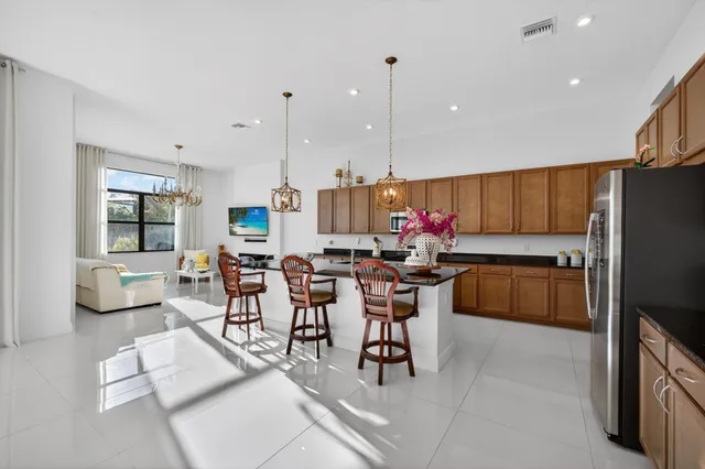 a kitchen with stainless steel appliances granite countertop a sink a stove and white cabinets