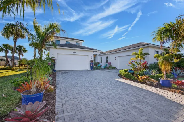 a front view of a house with a flower garden