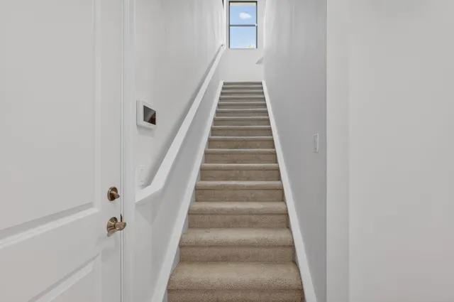 a living room with furniture fireplace and a large window