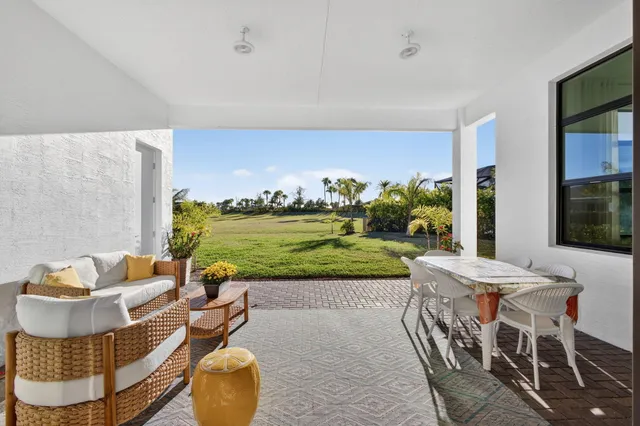 a view of a dining room with furniture and a chandelier